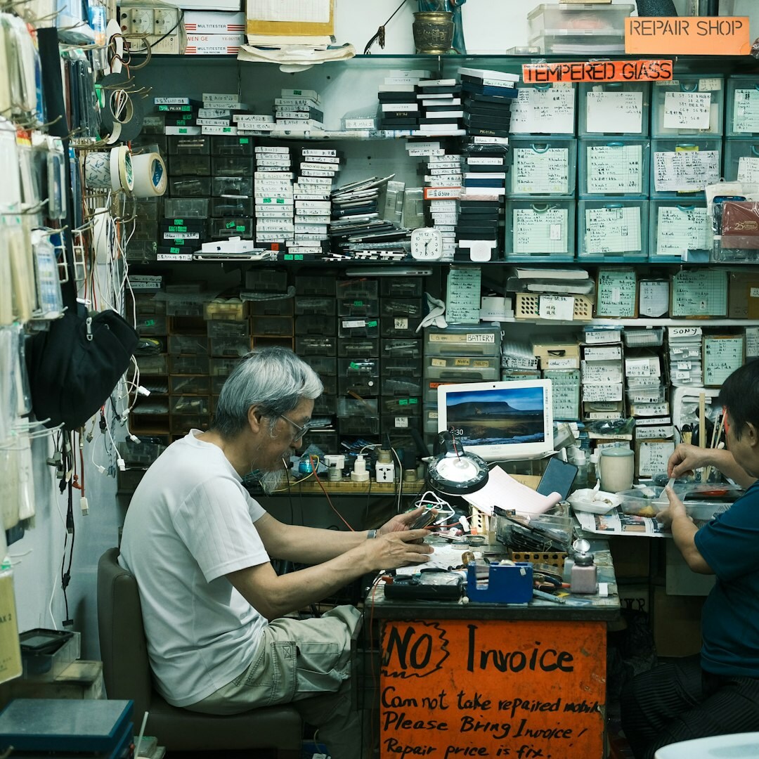 Artisan watchmaker examining a timepiece at a workbench