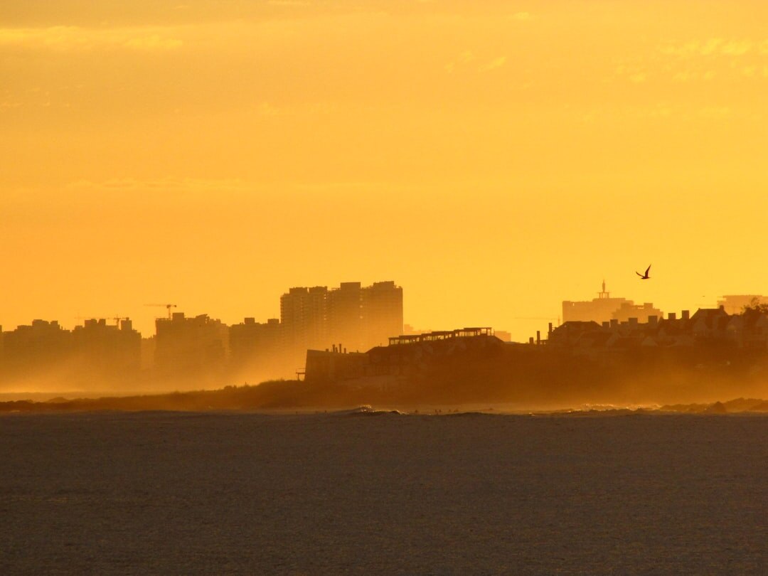 Golden hour skyline of Punta del Este with calm Atlantic waters